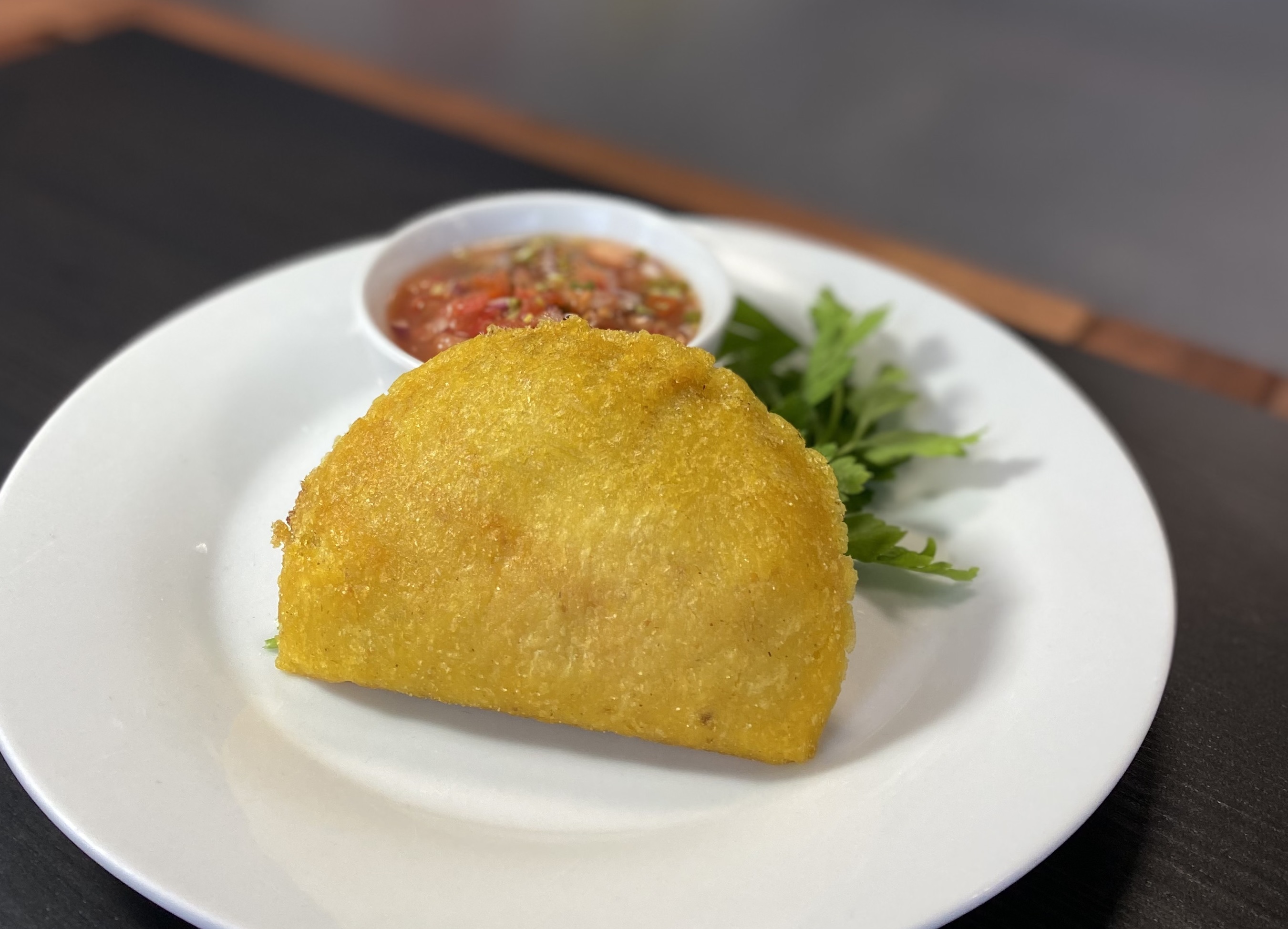 Authentic Colombian chicken empanada available at Bienvenidos Latin Market in Ottawa. Made with spiced chicken and Latin seasonings.